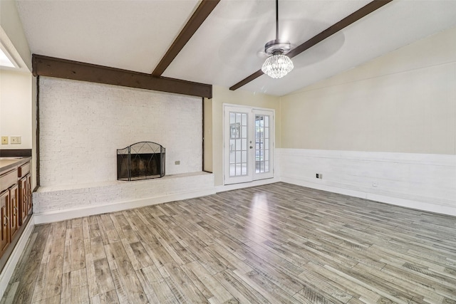 2622 Briar Hill Dr, Carrollton, TX 75007 - unfurnished living room with ceiling fan, a brick fireplace, wood finished floors, and wainscoting