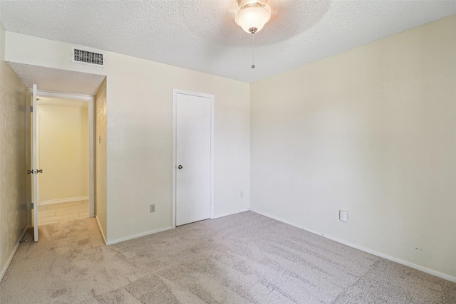 2622 Briar Hill Dr, Carrollton, TX 75007 - unfurnished bedroom with carpet floors, baseboards, a textured ceiling, and a ceiling fan