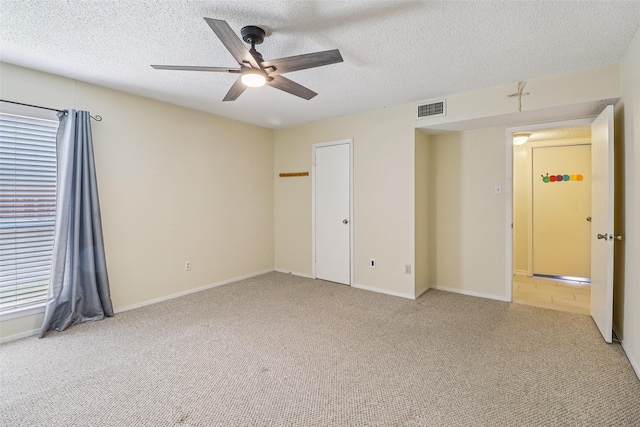 2622 Briar Hill Dr, Carrollton, TX 75007 - unfurnished bedroom with carpet floors, a textured ceiling, a ceiling fan, and baseboards