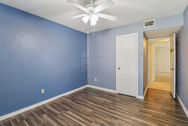 2622 Briar Hill Dr, Carrollton, TX 75007 - unfurnished bedroom with wood finished floors, a textured ceiling, baseboards, and a ceiling fan