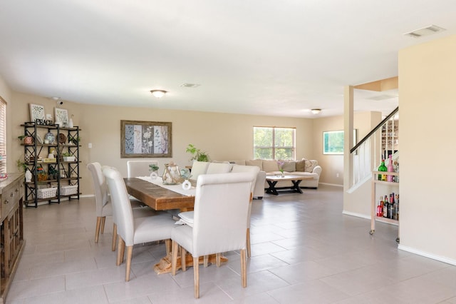 2300 Ash Grove Trl, Fort Worth, TX 76112 - dining space featuring baseboards, light tile patterned flooring, and stairway