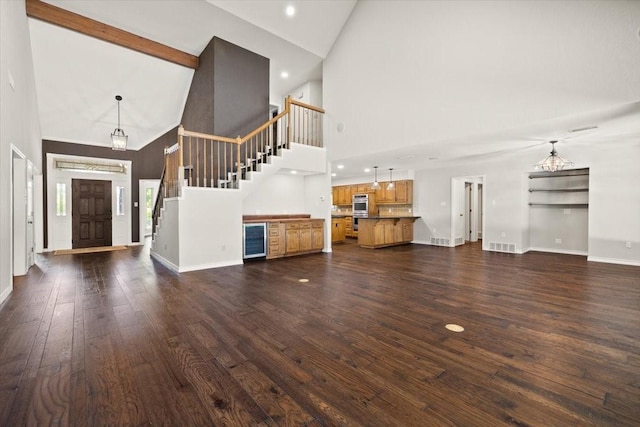 3519 Lake Powell Dr, Arlington, TX 76016 - unfurnished living room with high vaulted ceiling, beverage cooler, stairway, dark wood-style flooring, and baseboards