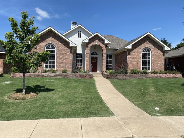 2900 Boyd St, Ennis, TX 75119 - view of front of home with brick siding, a front yard, and a chimney