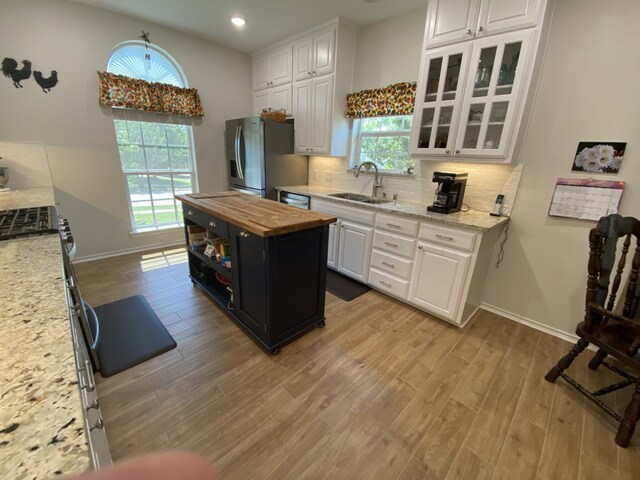 2900 Boyd St, Ennis, TX 75119 - kitchen with a sink, stainless steel appliances, butcher block countertops, white cabinets, and recessed lighting
