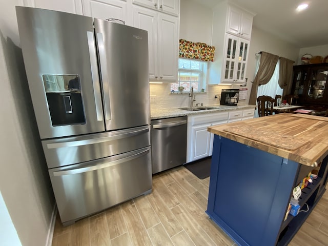 2900 Boyd St, Ennis, TX 75119 - kitchen with appliances with stainless steel finishes, wooden counters, a sink, white cabinets, and recessed lighting