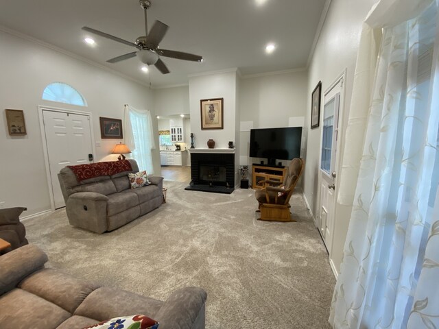 2900 Boyd St, Ennis, TX 75119 - carpeted living room with ceiling fan, ornamental molding, recessed lighting, a fireplace with raised hearth, and baseboards