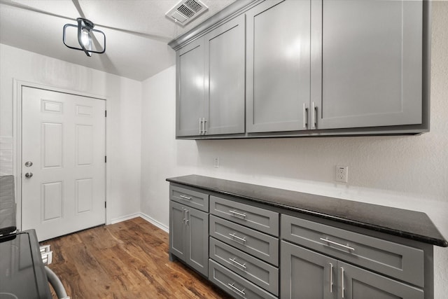 1111 N 11th St, Waco, TX 76707 - washroom featuring dark wood finished floors and baseboards