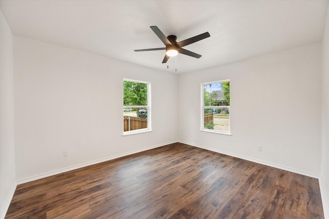 1111 N 11th St, Waco, TX 76707 - empty room with dark wood-style floors, ceiling fan, and baseboards