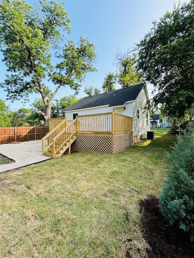 1111 N 11th St, Waco, TX 76707 - back of property featuring a wooden deck, central AC unit, a patio, and stairs