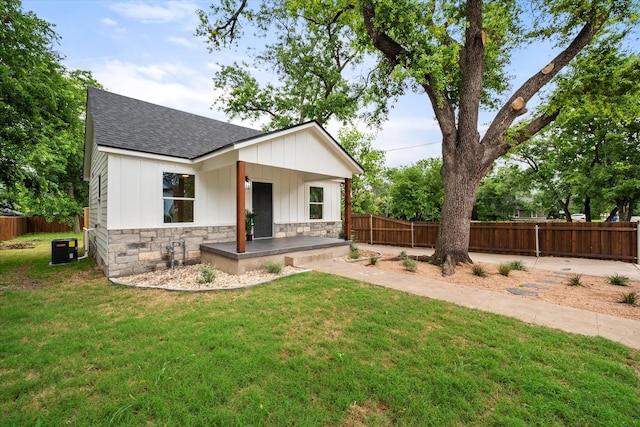 1111 N 11th St, Waco, TX 76707 - view of front of home featuring roof with shingles, stone siding, central AC, and board and batten siding