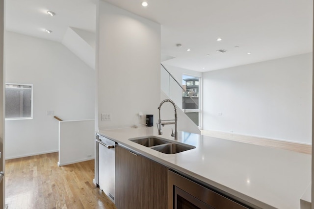2706 Throckmorton St Unit C, Dallas, TX 75219 - kitchen featuring a sink, light countertops, light wood-type flooring, dishwasher, and recessed lighting