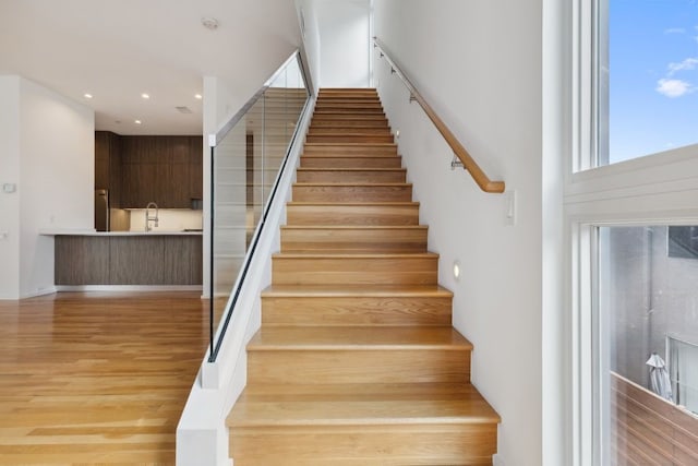 2706 Throckmorton St Unit C, Dallas, TX 75219 - stairway with wood finished floors and recessed lighting