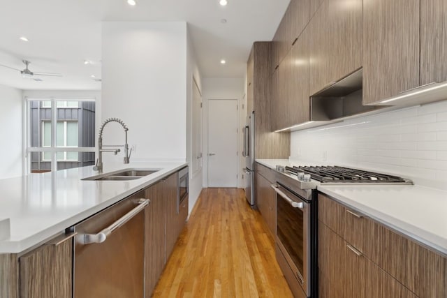 2706 Throckmorton St Unit C, Dallas, TX 75219 - kitchen with stainless steel appliances, a sink, modern cabinets, light countertops, and recessed lighting