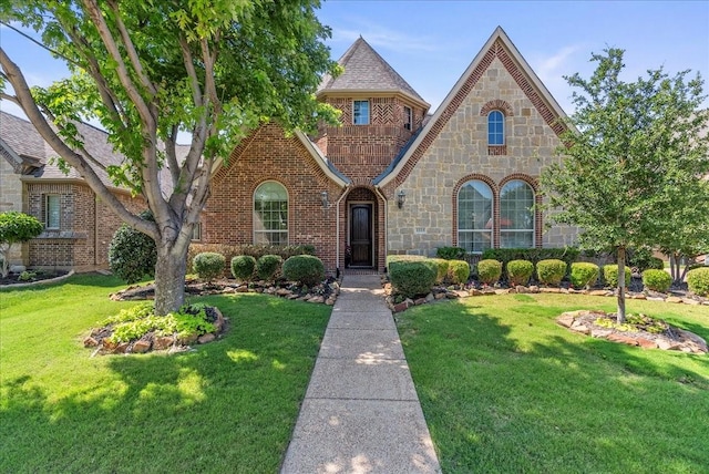 2223 Alisa Ln, Trophy Club, TX 76262 - view of front facade with a front lawn, stone siding, and brick siding