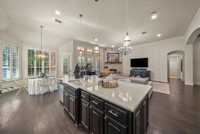 2223 Alisa Ln, Trophy Club, TX 76262 - kitchen featuring arched walkways, a sink, dark wood-style floors, a chandelier, and dishwasher