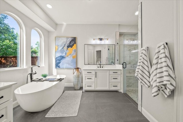 2223 Alisa Ln, Trophy Club, TX 76262 - bathroom featuring vanity, a shower stall, a freestanding tub, baseboards, and recessed lighting