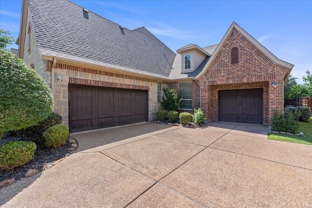 2223 Alisa Ln, Trophy Club, TX 76262 - view of front facade with driveway, a shingled roof, brick siding, and a garage