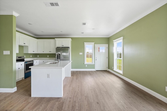 3231 Hillsdale Ave, Corsicana, TX 75110 - kitchen with appliances with stainless steel finishes, a sink, baseboards, light wood-style floors, and white cabinets