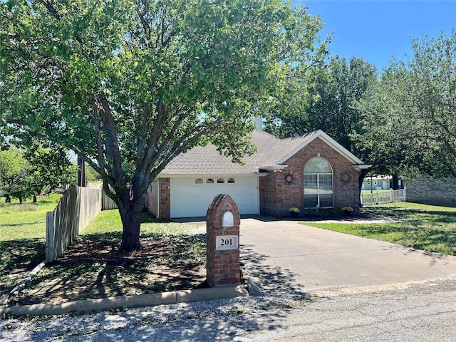 201 Park Rd, Nocona, TX 76255 - view of front of property with brick siding, a garage, concrete driveway, and roof with shingles