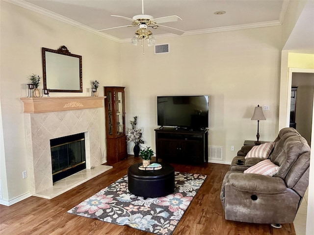 201 Park Rd, Nocona, TX 76255 - living room featuring ceiling fan, wood finished floors, a premium fireplace, ornamental molding, and baseboards