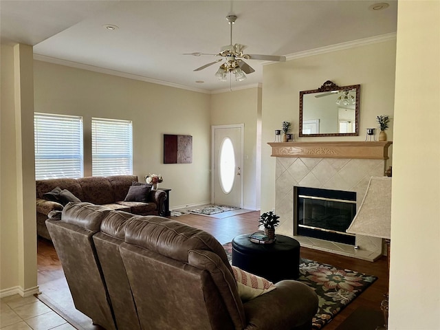 201 Park Rd, Nocona, TX 76255 - living area with a ceiling fan, ornamental molding, a tile fireplace, and baseboards