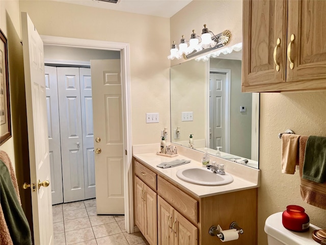 201 Park Rd, Nocona, TX 76255 - bathroom with tile patterned flooring, vanity, a closet, and toilet