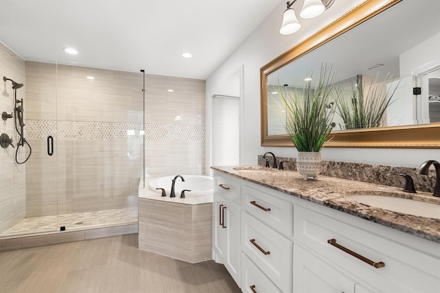 610 Sunset Ct, Argyle, TX 76226 - bathroom featuring a bath, double vanity, a stall shower, and recessed lighting