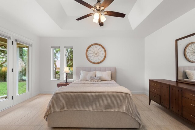 610 Sunset Ct, Argyle, TX 76226 - bedroom featuring a tray ceiling, a skylight, a ceiling fan, and baseboards