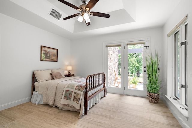 610 Sunset Ct, Argyle, TX 76226 - bedroom featuring a raised ceiling, access to exterior, baseboards, light wood-type flooring, and ceiling fan
