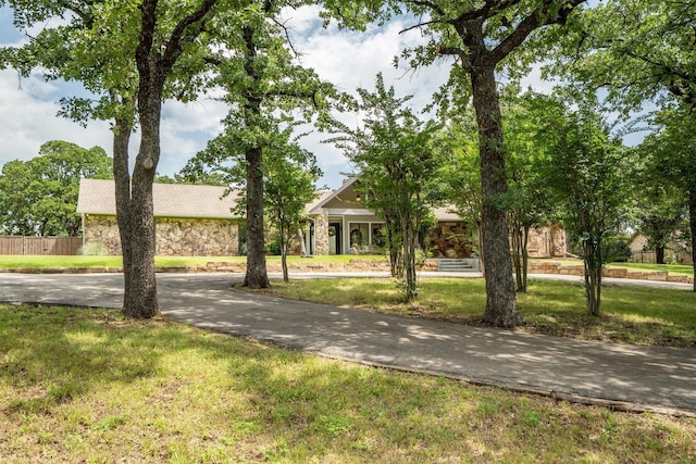 610 Sunset Ct, Argyle, TX 76226 - obstructed view of property with stone siding and driveway