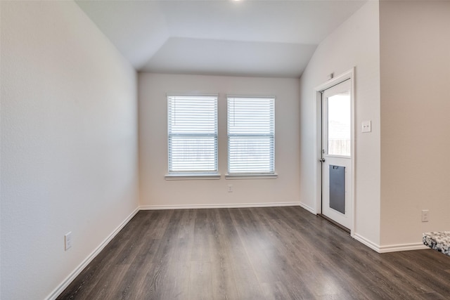 1302 Lowhill Dr, Royse City, TX 75189 - empty room with dark wood-style flooring, vaulted ceiling, and baseboards
