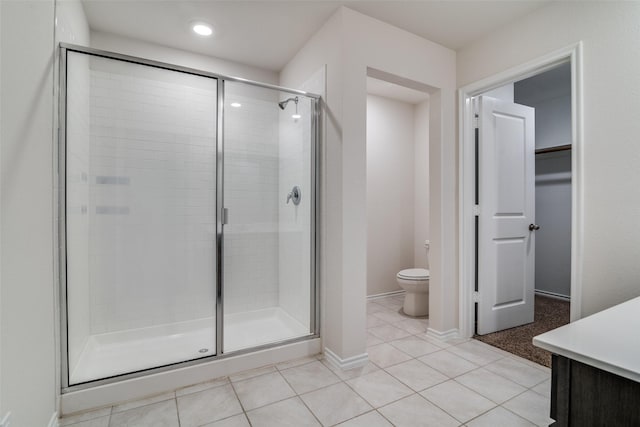 1302 Lowhill Dr, Royse City, TX 75189 - bathroom with a shower stall, toilet, tile patterned flooring, vanity, and a walk in closet