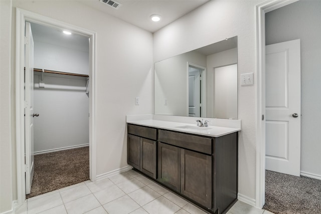 1302 Lowhill Dr, Royse City, TX 75189 - bathroom featuring vanity, a walk in closet, baseboards, and tile patterned floors