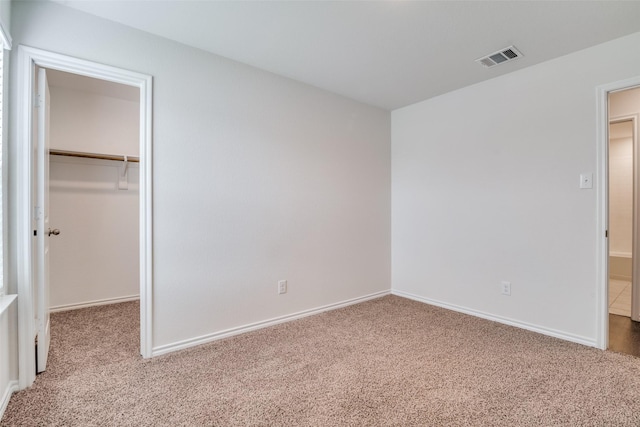 1302 Lowhill Dr, Royse City, TX 75189 - unfurnished bedroom with a walk in closet, carpet floors, baseboards, and a closet