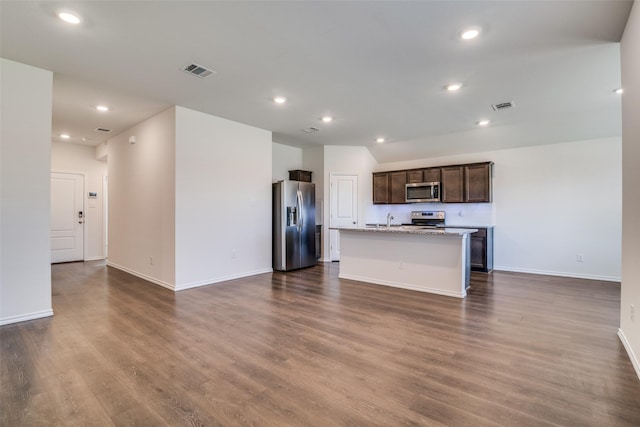 1302 Lowhill Dr, Royse City, TX 75189 - kitchen with stainless steel appliances, open floor plan, baseboards, dark wood-type flooring, and dark brown cabinets