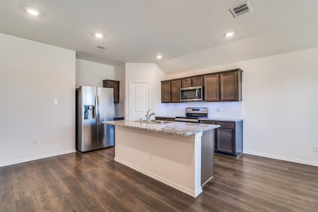 1302 Lowhill Dr, Royse City, TX 75189 - kitchen featuring stainless steel appliances, a sink, dark brown cabinets, dark wood-style flooring, and a center island with sink