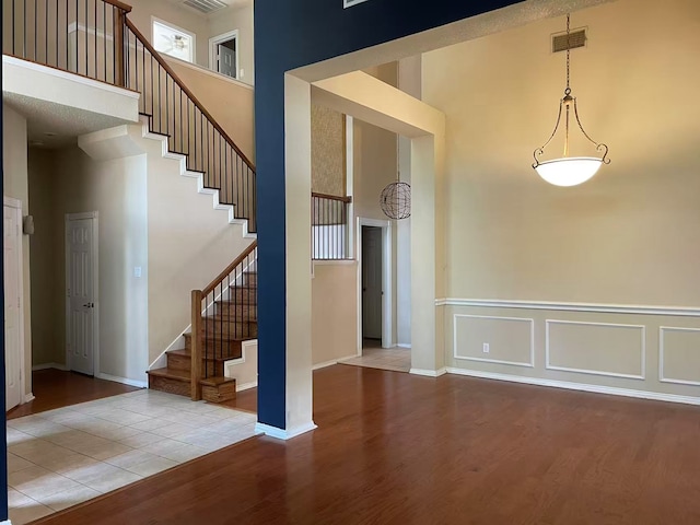 11008 Hermitage Ln, Frisco, TX 75035 - stairway with wood finished floors, a towering ceiling, and baseboards
