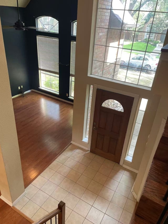 11008 Hermitage Ln, Frisco, TX 75035 - foyer with light wood-style flooring, ceiling fan, a towering ceiling, and baseboards