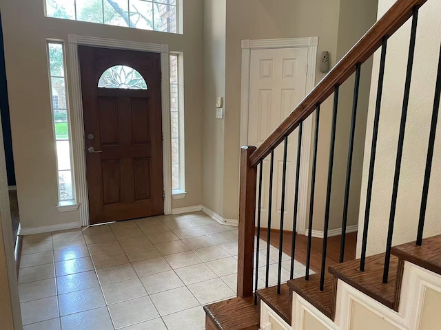 11008 Hermitage Ln, Frisco, TX 75035 - entryway featuring light tile patterned floors, stairs, plenty of natural light, and baseboards