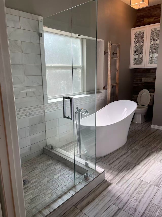 11008 Hermitage Ln, Frisco, TX 75035 - full bathroom featuring a stall shower, a freestanding tub, and toilet