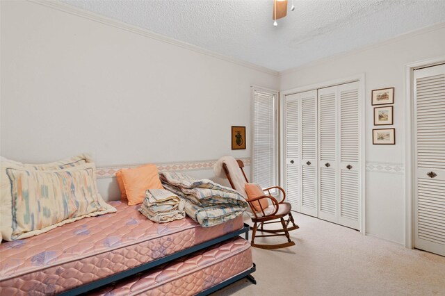 408 Hollyhill Ln, Denton, TX 76205 - carpeted bedroom with crown molding, a textured ceiling, and ceiling fan
