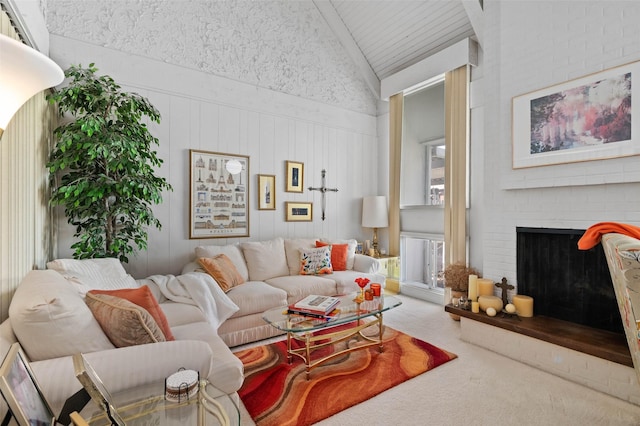 408 Hollyhill Ln, Denton, TX 76205 - carpeted living room featuring lofted ceiling, a brick fireplace, and a decorative wall