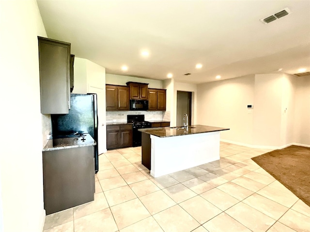 2518 Lavender Ln, Glenn Heights, TX 75154 - kitchen with black appliances, a sink, light tile patterned floors, recessed lighting, and decorative backsplash