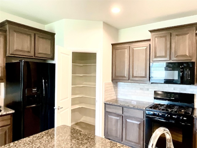 2518 Lavender Ln, Glenn Heights, TX 75154 - kitchen with black appliances, light stone counters, and decorative backsplash