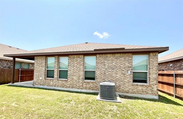 2518 Lavender Ln, Glenn Heights, TX 75154 - rear view of house featuring central AC unit, a shingled roof, and brick siding