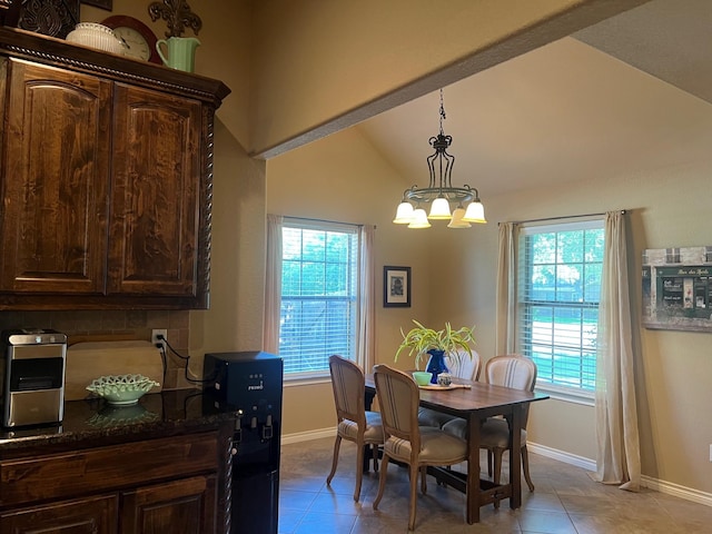 1014 Royal Ln, Graham, TX 76450 - dining area featuring a chandelier, light tile patterned floors, baseboards, and vaulted ceiling