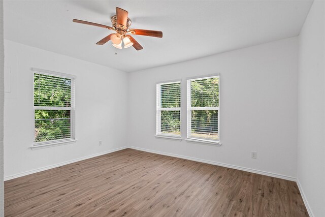 307 Soward Ave, Weatherford, TX 76086 - empty room with wood finished floors, baseboards, and ceiling fan