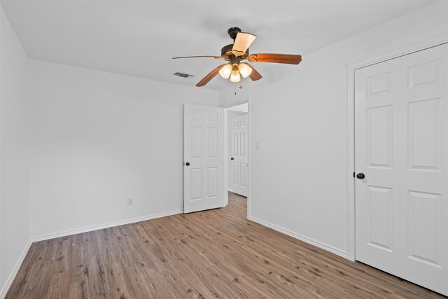 307 Soward Ave, Weatherford, TX 76086 - unfurnished bedroom with wood finished floors, baseboards, and ceiling fan