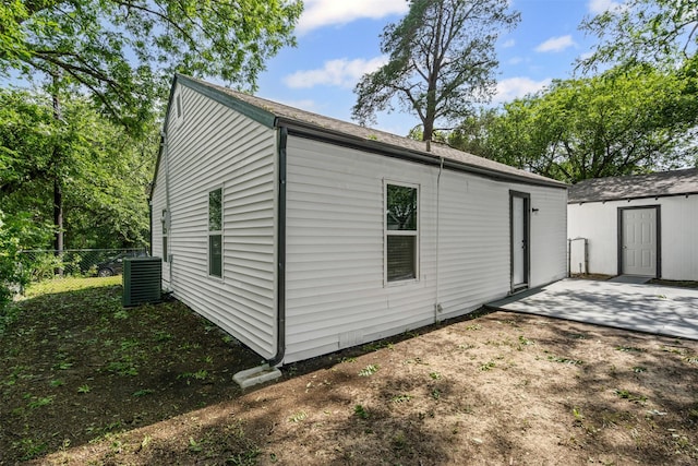 307 Soward Ave, Weatherford, TX 76086 - view of side of home with a patio area, central AC unit, and an outbuilding