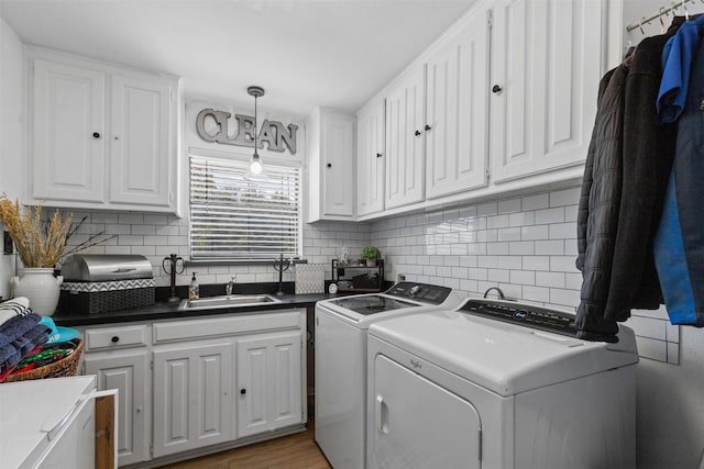 3512 Ridglea Country Club Dr, Fort Worth, TX 76116 - laundry area featuring cabinet space, washer and dryer, and light wood-style floors